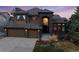 Stunning two-story home featuring a symmetrical facade, two-car garage, and beautiful desert landscaping at 34 Amaranth Dr, Littleton, CO 80127