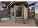 Beautiful home exterior features a wooden deck, brick accents and many windows with beautiful views at 34 Amaranth Dr, Littleton, CO 80127