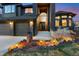 Well-lit home boasts meticulously landscaped front yard, two-car garage, and inviting entryway with architectural details at 34 Amaranth Dr, Littleton, CO 80127