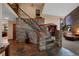 Grand foyer boasts custom stone wall and staircase, adding rustic elegance to the home's design at 34 Amaranth Dr, Littleton, CO 80127