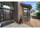 Beautiful front entryway, featuring a solid wood front door, brick accents and a cozy front porch at 34 Amaranth Dr, Littleton, CO 80127