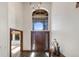 The tall and bright foyer has a dark wood front door and slate flooring, leading to other rooms at 34 Amaranth Dr, Littleton, CO 80127