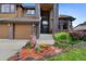 Stately home featuring a grand entryway with a beautiful landscape with an inviting walkway at 34 Amaranth Dr, Littleton, CO 80127