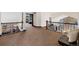 Hallway view featuring iron railing and stone accent wall on main level, with a cozy sitting area at 34 Amaranth Dr, Littleton, CO 80127