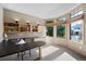 Bright home office features a built-in desk, shelving, and large windows with neighborhood views at 34 Amaranth Dr, Littleton, CO 80127
