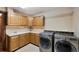 Well-equipped laundry room with ample storage, counter space, and modern washer/dryer at 34 Amaranth Dr, Littleton, CO 80127