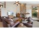 Bright living room with a stone fireplace, high ceilings, and comfortable seating at 34 Amaranth Dr, Littleton, CO 80127
