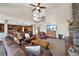 Spacious living room showcases an open floor plan, stone fireplace, and access to the kitchen at 34 Amaranth Dr, Littleton, CO 80127