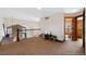 Cozy loft area features a stone accent wall, iron railing, and a glimpse of an office through an open doorway at 34 Amaranth Dr, Littleton, CO 80127