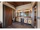 Stylish main bathroom showcases custom vanities, barn door, and modern lighting fixtures at 34 Amaranth Dr, Littleton, CO 80127