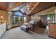 Cozy main bedroom retreat features a vaulted ceiling, exterior views, and a barn door at 34 Amaranth Dr, Littleton, CO 80127