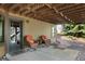 Enjoy the outdoors from the covered patio with comfortable seating and stone landscaping at 34 Amaranth Dr, Littleton, CO 80127
