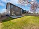 Backyard featuring green lawn, concrete patio, and views of the surrounding neighborhood at 1826 Sunshine Ave, Longmont, CO 80504