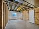 Unfinished basement space with studded walls, a small window and exposed ceiling fixtures at 1826 Sunshine Ave, Longmont, CO 80504