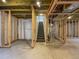 Unfinished basement with exposed framing, utilities, and staircase leading to the upper level at 1826 Sunshine Ave, Longmont, CO 80504