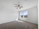 Spacious bedroom featuring carpet flooring, a ceiling fan, two windows, and neutral paint at 1826 Sunshine Ave, Longmont, CO 80504