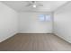 Clean, empty bedroom with neutral carpet, two windows, white walls and ceiling fan at 1826 Sunshine Ave, Longmont, CO 80504