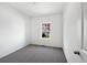 Cozy bedroom with neutral carpet, and a bright window providing natural light and view of outside at 1826 Sunshine Ave, Longmont, CO 80504