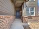 Inviting entrance with a classic blue front door, brick accents, and manicured landscaping at 1826 Sunshine Ave, Longmont, CO 80504