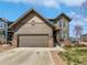 Charming two-story home with a two-car garage, landscaped yard, and neutral brown siding at 1826 Sunshine Ave, Longmont, CO 80504