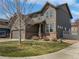 Two-story home featuring a well-maintained lawn, attached garage, and classic brick accents at 1826 Sunshine Ave, Longmont, CO 80504