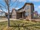 Charming two-story home featuring a well-maintained lawn, attached garage, and classic brick accents at 1826 Sunshine Ave, Longmont, CO 80504