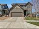 Charming two-story home with a two-car garage, landscaped yard, solar panels and neutral brown siding at 1826 Sunshine Ave, Longmont, CO 80504