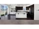 Modern kitchen with dark wood cabinets, an island with granite countertops, and stainless steel appliances at 1826 Sunshine Ave, Longmont, CO 80504