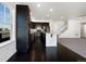 Modern kitchen boasts dark cabinetry, stainless steel appliances, and a spacious island with a granite countertop at 1826 Sunshine Ave, Longmont, CO 80504