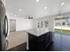 Open-concept kitchen and living room, island with granite countertop, and large windows for natural light at 1826 Sunshine Ave, Longmont, CO 80504