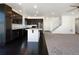 Open-concept space with an island kitchen, dark cabinets, and new stainless steel appliances at 1826 Sunshine Ave, Longmont, CO 80504