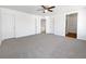 Large main bedroom features plush carpeting, ceiling fan, and multiple doors to en suite bathroom and closet at 1826 Sunshine Ave, Longmont, CO 80504