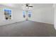 Spacious main bedroom with carpet, a ceiling fan, and multiple windows offering natural light at 1826 Sunshine Ave, Longmont, CO 80504