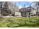 Expansive backyard with a patio, basketball hoop, outdoor dining, and beautifully manicured lawn at 121 N Marion St, Denver, CO 80218