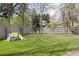 Well-maintained backyard featuring a playground, grassy area, and partial fencing at 121 N Marion St, Denver, CO 80218