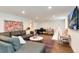 Open basement area featuring stylish seating, TV, play area, and herringbone floors at 121 N Marion St, Denver, CO 80218
