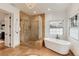 Luxurious bathroom featuring a walk-in shower, soaking tub, and upscale finishes with natural light at 121 N Marion St, Denver, CO 80218