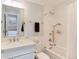 Clean bathroom with bright natural light, a tub shower and a modern vanity with a nice mirror at 121 N Marion St, Denver, CO 80218