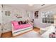 Charming bedroom with bright floral wallpaper, playful decor, and natural light from multiple windows at 121 N Marion St, Denver, CO 80218