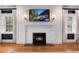 Living room fireplace with white mantel and hearth, flanked by windows with flowing white curtains at 121 N Marion St, Denver, CO 80218