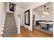 Foyer boasts hardwood floors, a staircase, and a view into dining area with an elegant chandelier at 121 N Marion St, Denver, CO 80218