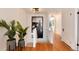 Bright foyer with wood floors and staircase with plant accents to showcase the well maintained area at 121 N Marion St, Denver, CO 80218