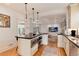 Open-concept kitchen with island, stainless steel appliances, and seamlessly connected living space at 121 N Marion St, Denver, CO 80218