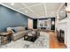 Living room with blue accent walls, hardwood floors, a fireplace, and comfortable seating at 121 N Marion St, Denver, CO 80218