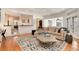 Open-concept living area with hardwood floors, a large rug, and view to the dining space at 121 N Marion St, Denver, CO 80218