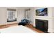 Bright main bedroom with fireplace, window seats, and TV, offering a cozy and relaxing retreat at 121 N Marion St, Denver, CO 80218