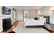 Sunlit main bedroom features a cozy fireplace, neutral decor, and exterior access to a balcony at 121 N Marion St, Denver, CO 80218