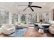 Bright sunroom features vaulted ceilings, brick floors, and large windows overlooking the backyard at 121 N Marion St, Denver, CO 80218