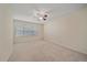 Empty bedroom featuring carpet, ceiling fan, and a large window at 11150 Night Heron Dr, Parker, CO 80134
