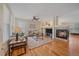 Cozy living room featuring a fireplace, hardwood floors, and comfortable seating at 11150 Night Heron Dr, Parker, CO 80134